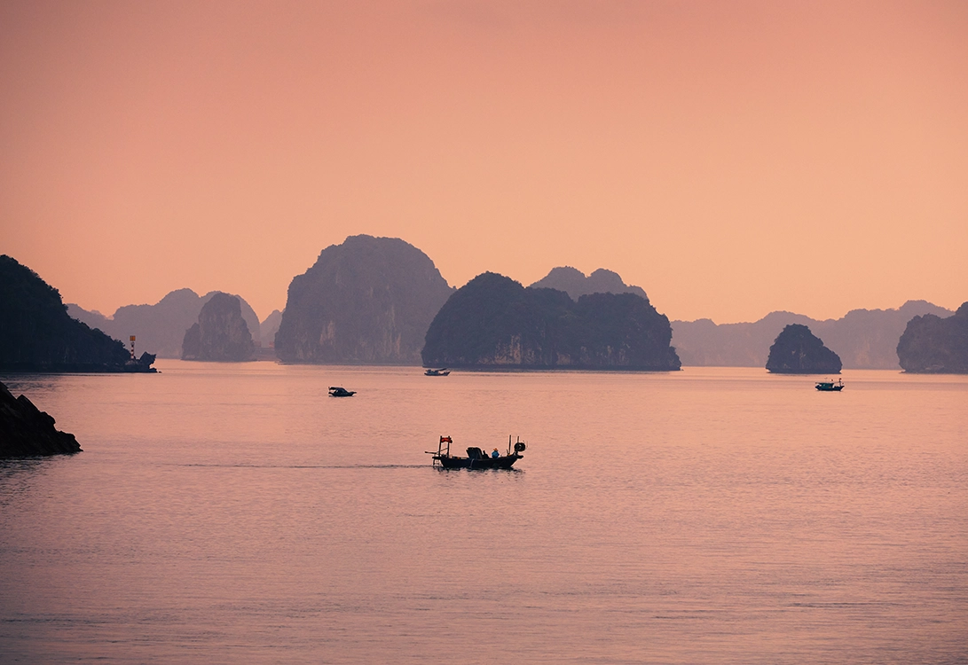 Limestone islands and quiet waters across Ha Long Bay and Bai Tu Long Bay during a two-day overnight journey aboard Sea Stars Cruise